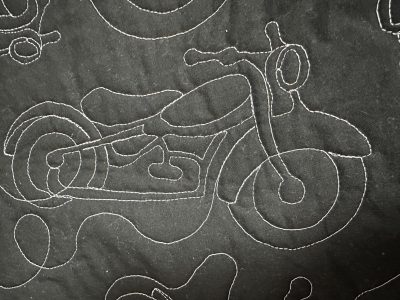 The quilting design is motorcycles.