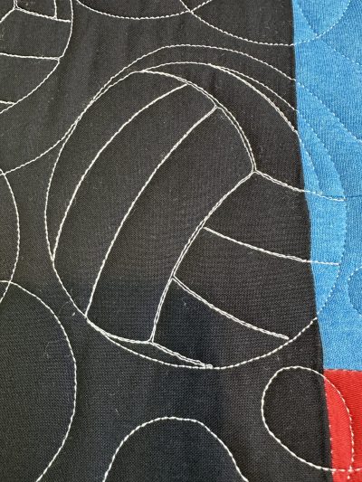 Volleyballs are quilted through all layers for the quilting.